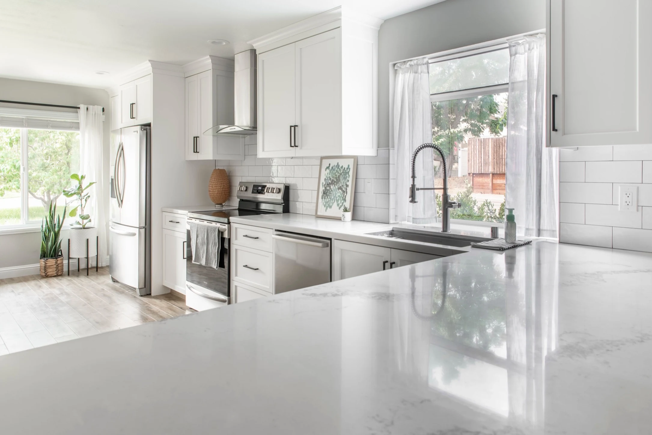 Bright completed kitchen with white cabinetry and island